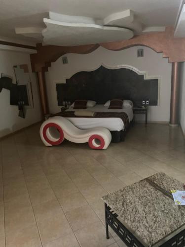 a bedroom with a bed with a car on it at Motel isis in Guadalajara
