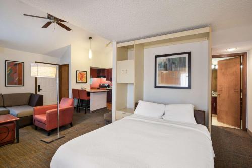a hotel room with a bed and a living room at SenS Suites Livermore; SureStay Collection by Best Western in Livermore