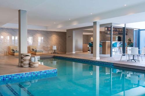 a swimming pool in a house with a house at Radisson Hotel & Convention Centre Johannesburg, O.R. Tambo in Johannesburg