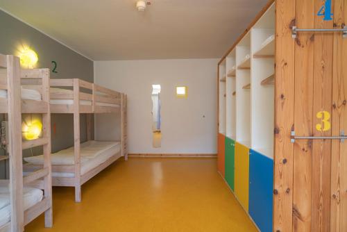 a room with two bunk beds and a door at BIG MAMA Berlin in Berlin