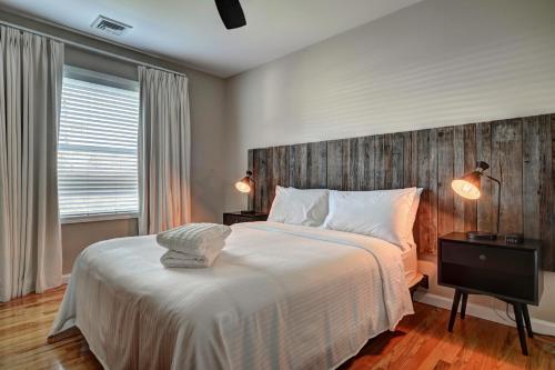 a bedroom with a large bed with a wooden headboard at The Montauk Beach House in Montauk