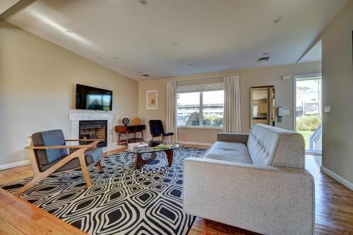 a living room with a couch and a fireplace at The Montauk Beach House in Montauk