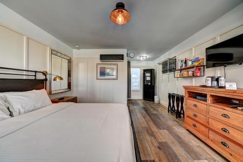 a bedroom with a large bed and a wooden dresser at The Montauk Beach House in Montauk