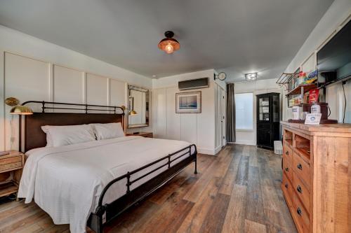 a bedroom with a large bed and a wooden floor at The Montauk Beach House in Montauk