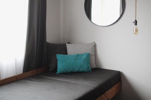 a room with a bed with a mirror and a window at Adrift Hotel in Long Beach