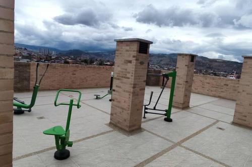a group of exercise equipment on the roof of a building at Edificios de apartamentos central con ascensor 604 in Bogotá