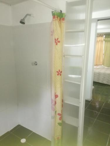 a shower curtain with flowers on it in a bathroom at ApartaEstudio Jazmines Santa Rosa de Cabal in Santa Rosa de Cabal
