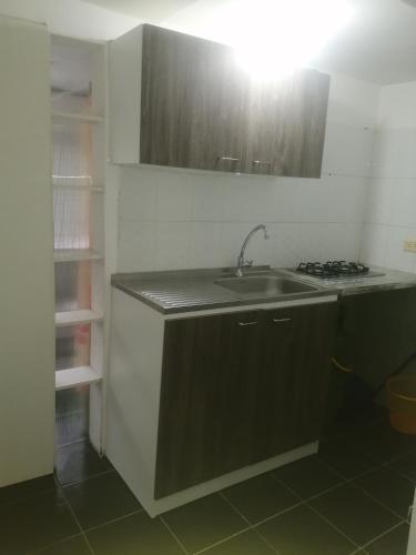a kitchen with a sink and a stove at ApartaEstudio Jazmines Santa Rosa de Cabal in Santa Rosa de Cabal