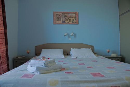 a bedroom with a bed with towels on it at Dimitropoulos Apartments in Eleonas