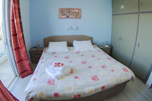a bedroom with a bed with a cake on it at Dimitropoulos Apartments in Eleonas