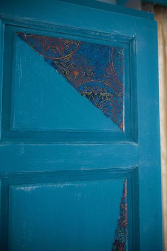 a blue door with a painting on it at Dimitropoulos Apartments in Eleonas