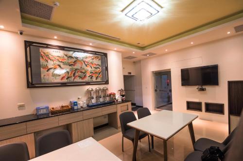 a meeting room with a table and a tv at Dongdaemun Boutique Hotel in Hualien City