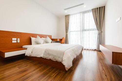 a bedroom with a large bed and a large window at Five Star Westlake 1st-4th Floors Hotel & Serviced Apartment in Hanoi