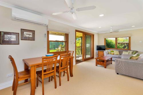 a dining room and living room with a table and chairs at The Ballabourneen Estate in Lovedale