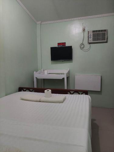 a hospital room with a bed and a tv at Dweller's Pensione in Iloilo City