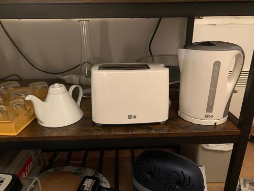 two toasters and a blender on a shelf at Biarritz centre bel Apt 2 pièces rue calme in Biarritz