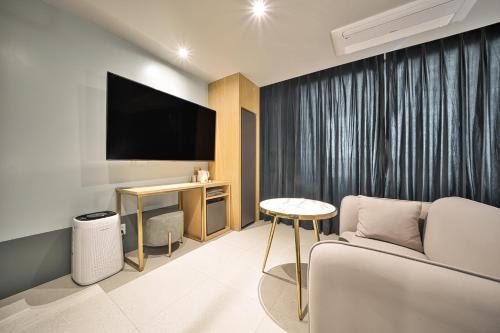 a living room with a couch and a tv at Browndot Terrace Pohang Passenger Terminal in Pohang