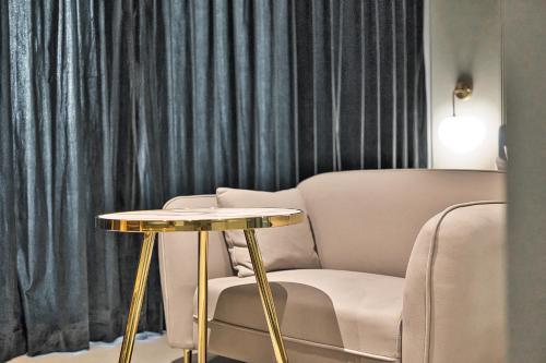 a living room with a table and a chair at Browndot Terrace Pohang Passenger Terminal in Pohang