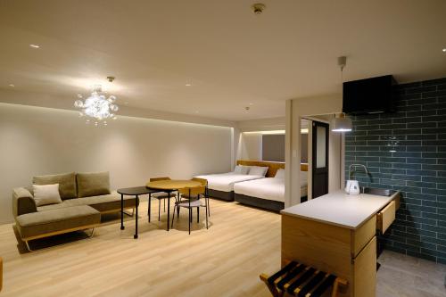 a living room with a couch and a table at Namba Hara apartment in Osaka