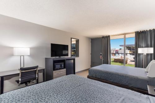 a hotel room with two beds and a flat screen tv at Econo Lodge in Cave City