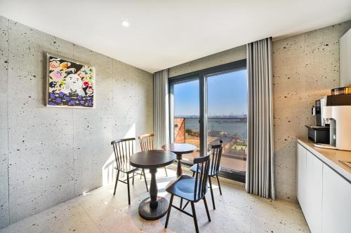 a kitchen with a table and chairs and a window at Browndot Terrace Pohang Passenger Terminal in Pohang