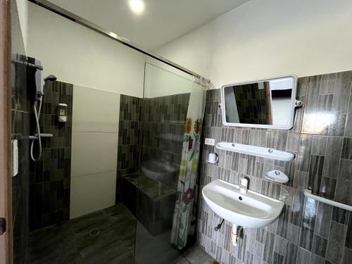 a bathroom with a sink and a mirror at Ocean Bay Beach Resort in Dalaguete