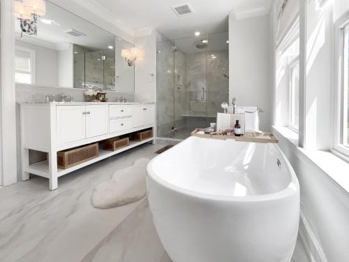 a large white bathroom with a tub and a sink at New Construction Modern Luxury Retreat w 6 Beds in Southampton