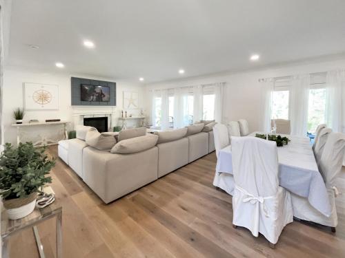 a living room with a white couch and a fireplace at New Construction Modern Luxury Retreat w 6 Beds in Southampton