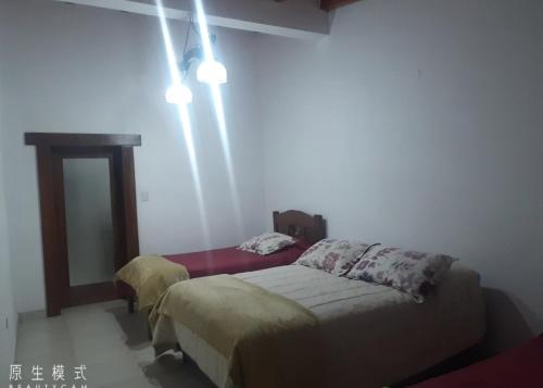 a bedroom with two beds in a room at Hospedaje lupe in Cachí