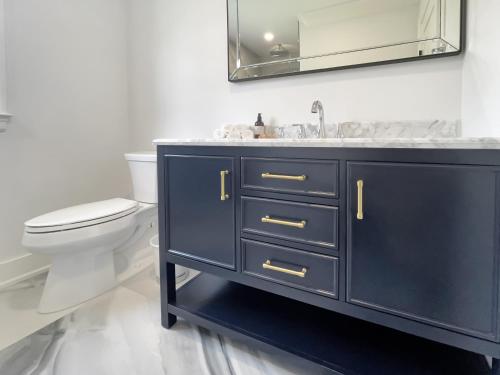 a bathroom with a sink and a toilet at New Construction Modern Luxury Retreat w 6 Beds in Southampton