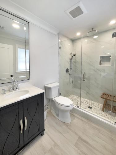 a bathroom with a toilet sink and a shower at New Construction Modern Luxury Retreat w 6 Beds in Southampton