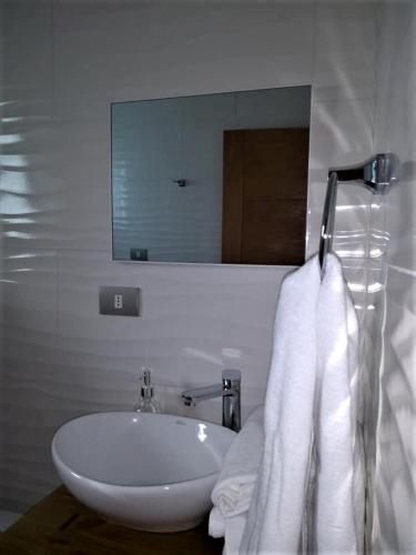 a bathroom with a white sink and a mirror at EL RINCON DE LÚ in Chile Chico