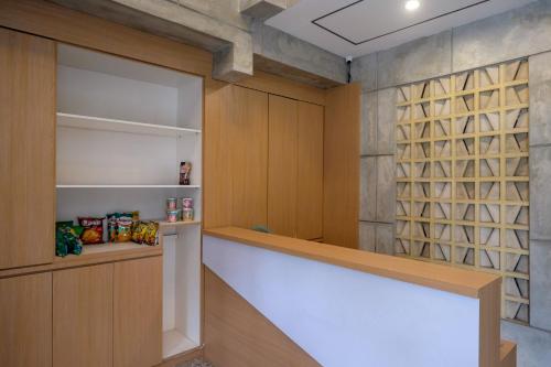 a walk in pantry with wood paneling and a wall at Urbanview Hotel Syariah Artamara Tegal by RedDoorz in Tegal