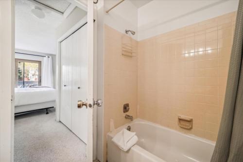 a bathroom with a bath tub and a sink at Winter Point 20 in Breckenridge