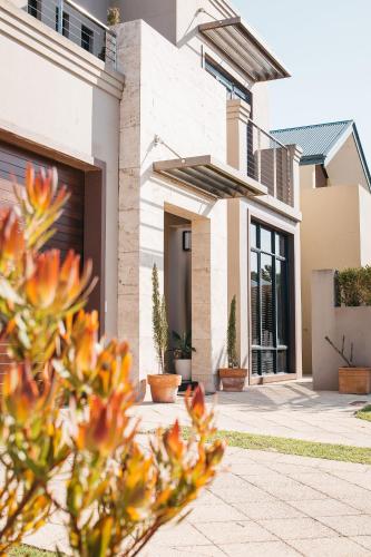 a house with plants in front of it at Banksia by the Bay in Emu Point