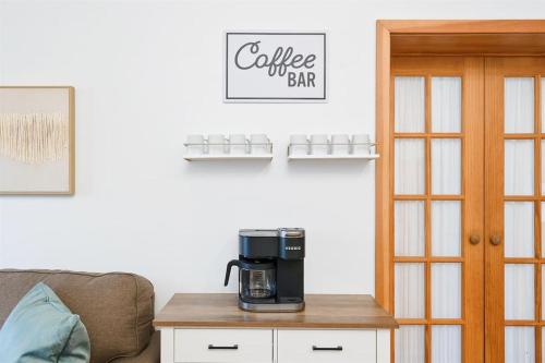 a coffee maker on a table in a living room at Cannon beach vibes, steps to the beach,WIFI,3 full bedroom en suites with 3 fireplaces,Near Downtown in Cannon Beach