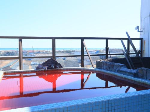 a swimming pool on top of a building at Seaside Hotel Kujukuri in Sammu