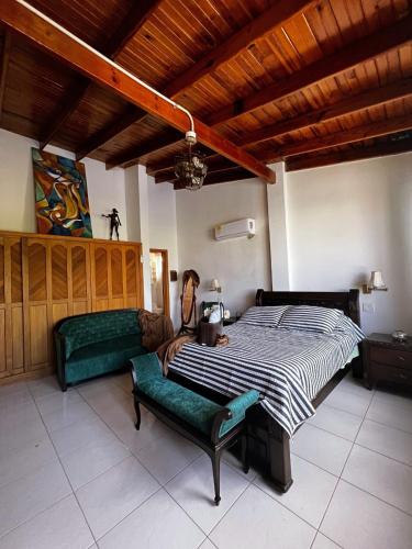 a bedroom with a large bed and a couch at Sunset Paradise in San Andrés