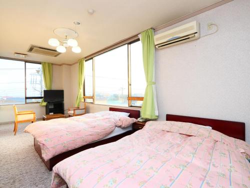 Postel nebo postele na pokoji v ubytování Seaside Hotel Kujukuri