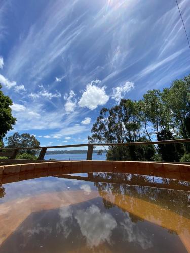a bridge over a pool of water with the sky in the background at CIPRES Ecolodge & Spa in Frutillar