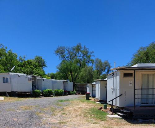 a row of mobile homes parked in a parking lot at Taroom Caravan & Tourist Park in Taroom