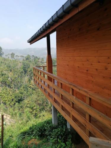 a wooden house on a hill with a view at Green Nature Paradise Ella in Ella