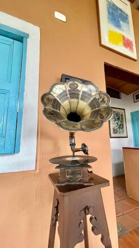 a fan sitting on top of a stand next to a wall at Cabaña en la Mesa de los Santos in Pescadero