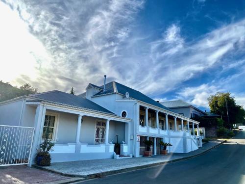 a white building on the side of a street at 1 Royal Street Guesthouse in Riebeek-Kasteel