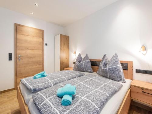 ein Schlafzimmer mit zwei blauen Kissen auf einem Bett in der Unterkunft Group apartment in Piesendorf with barbecue in Piesendorf