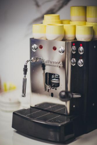 a coffee maker with bowls on top of it at RUBO Hotel in Shumen