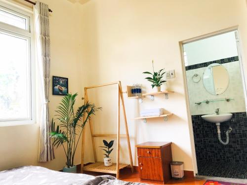 a bathroom with a sink and a mirror at NHỚ House II in Da Lat