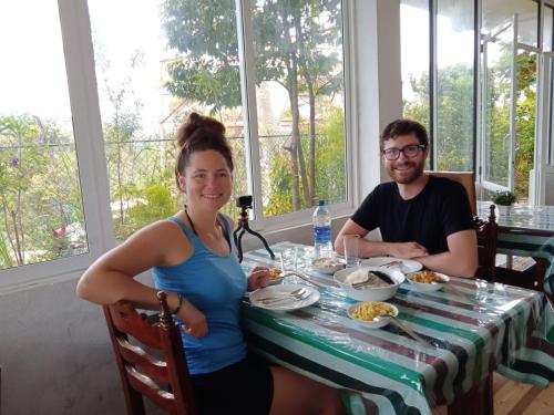 a man and a woman sitting at a table with food at The Rock Face in Ella