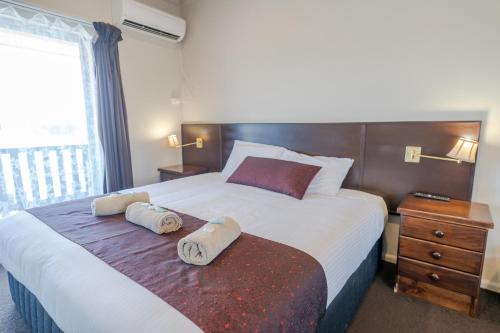 a hotel room with a bed with towels on it at Halfway Motel in Eden