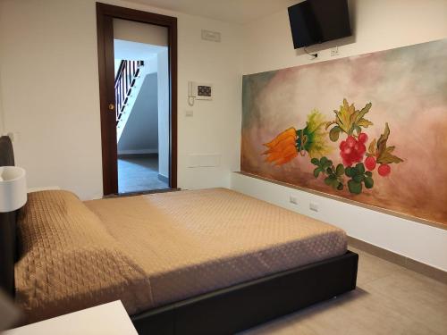 a bedroom with a bed and a painting on the wall at Agriturismo Ariston ONC 1484 in Sabaudia